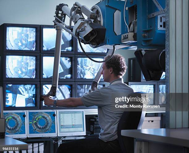 fusion reactor scientist at work - young man scientist stock pictures, royalty-free photos & images