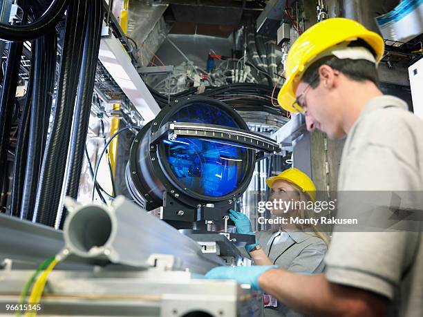 fusion reactor scientists with lens - lens flair stock-fotos und bilder