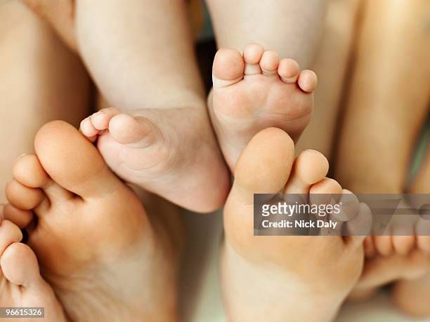 a cluster of bare feet - mens bare feet fotografías e imágenes de stock