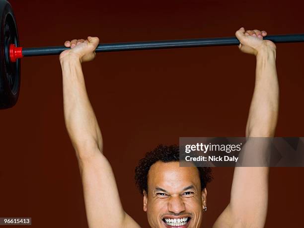 a male working out using weights - serrare i denti foto e immagini stock