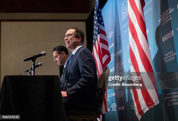 Steven Mnuchin, U.S. Treasury secretary, right, speaks as Tony Sayegh, spokesman for the U.S. Treasury Department, listens during a news conference...