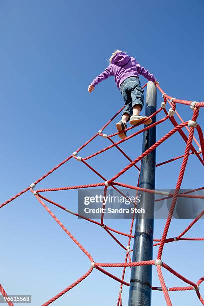 boy climbing junglegym - jungle gym stock pictures, royalty-free photos & images