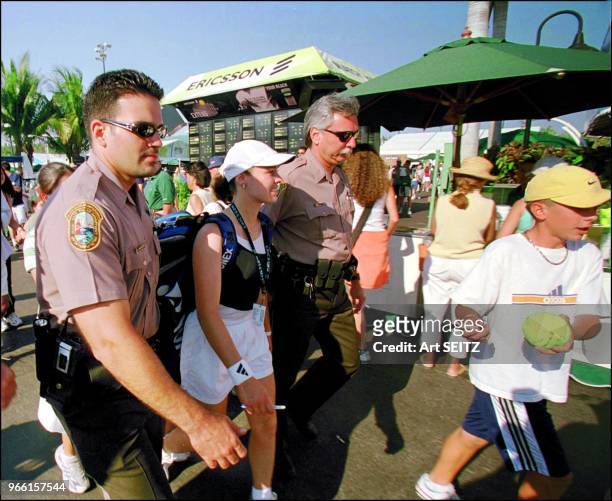 No.1 in the world ranked Swiss Miss Martina Hingis is escorted across the grounds at the Ericsson Tennis Championships by two policemen. A local...