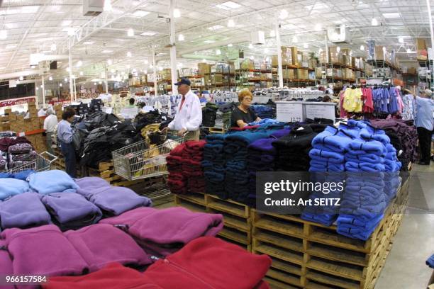 Costco Wholesale Warehouse-No frills bulk purchase shopping. Wideangle interior views of Cosco's airplane hangar size , concrete slab aisles, wide...