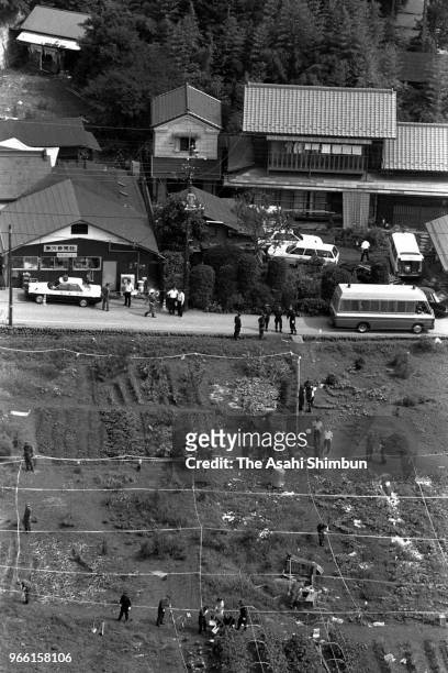In this aerial image, police officers investigate the site where suspect TSutomu Miyazaki confessed that he had burnt bones of killed girl on August...