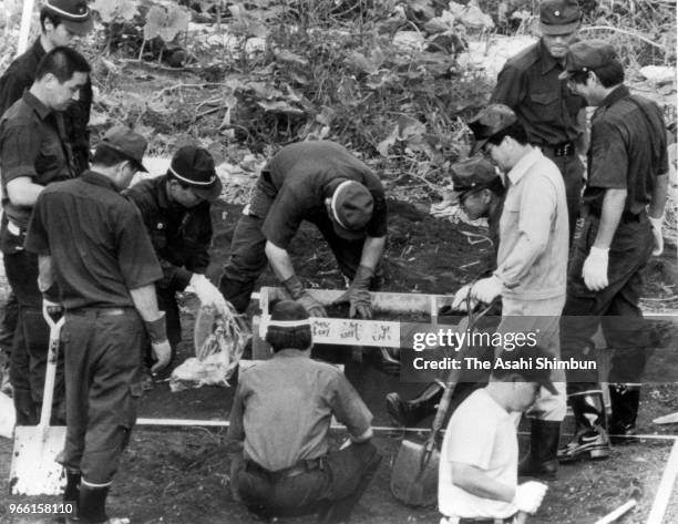 Police officers investigate the site where suspect TSutomu Miyazaki confessed that he had burnt bones of killed girl on August 6, 1989 in Itsukaichi,...