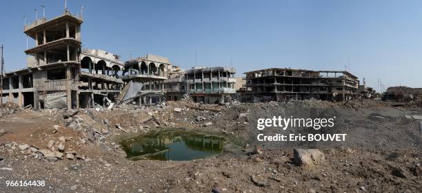 Immeubles en ruines et cratère creusé par une explosion, le 29 mars 2017, Mossoul, Irak.