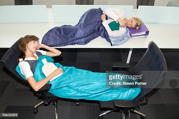 business women sleeping in the office - labor camp bildbanksfoton och bilder