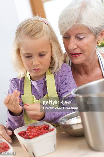 girl with grandmother cooking jam - jam making generations photos et images de collection