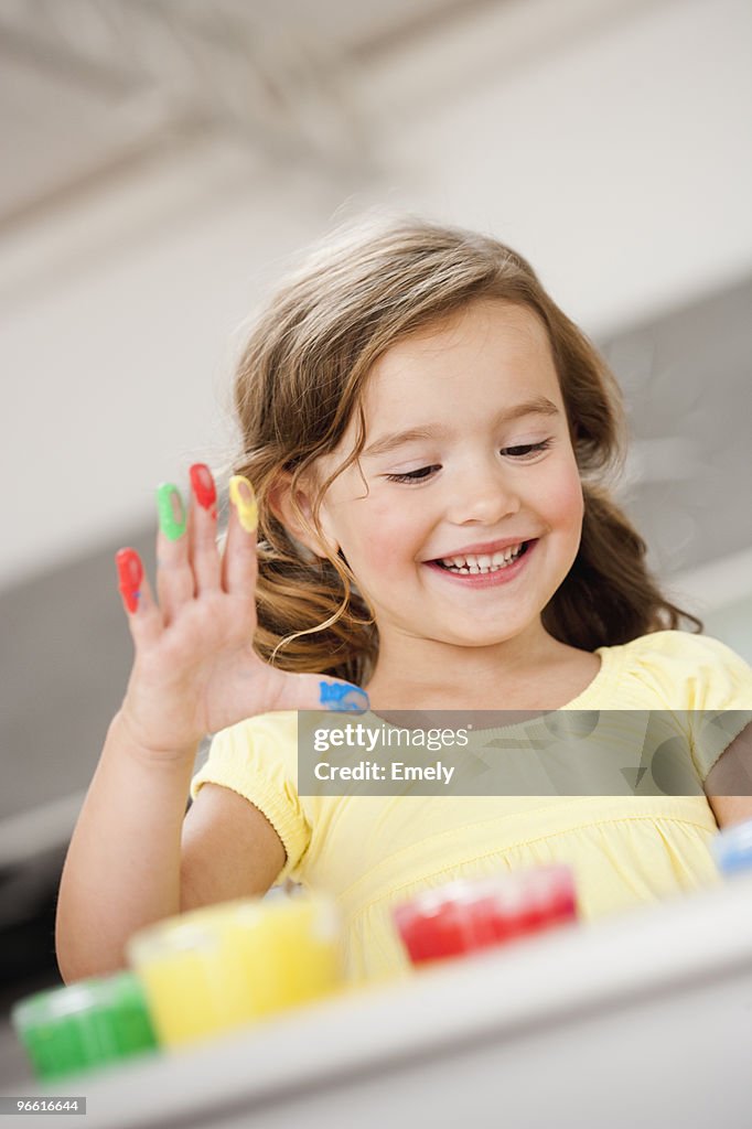 Young girl playing with colours