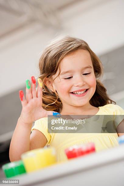 young girl playing with colours - 4 girls finger painting foto e immagini stock