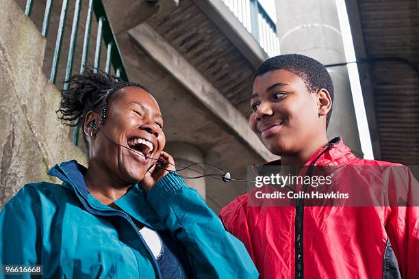 teenage boy with mother on headphones - teenage boys stock photos et images de collection