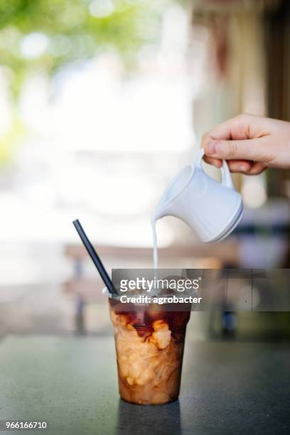 pouring cream in cold brew coffee - iced coffee stock pictures, royalty-free photos & images