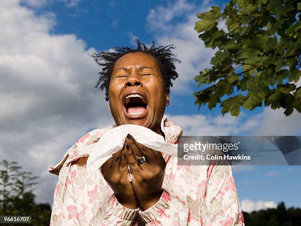 woman sneezing outside - sneezing stock pictures, royalty-free photos & images