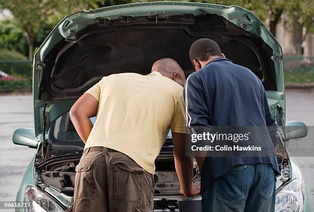 father & son working on car - vehicle hood stock pictures, royalty-free photos & images