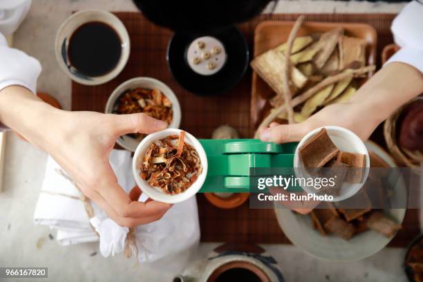 doctor measuring herbal medicines with weighing scales - angelica hale stock pictures, royalty-free photos & images