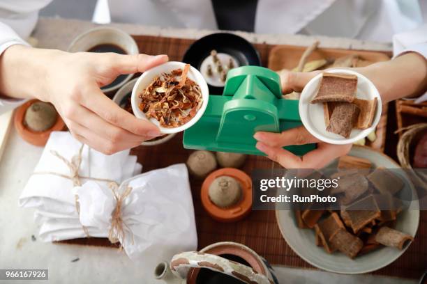 doctor weighing herbal medicines with weighing scales - angelica hale stock pictures, royalty-free photos & images