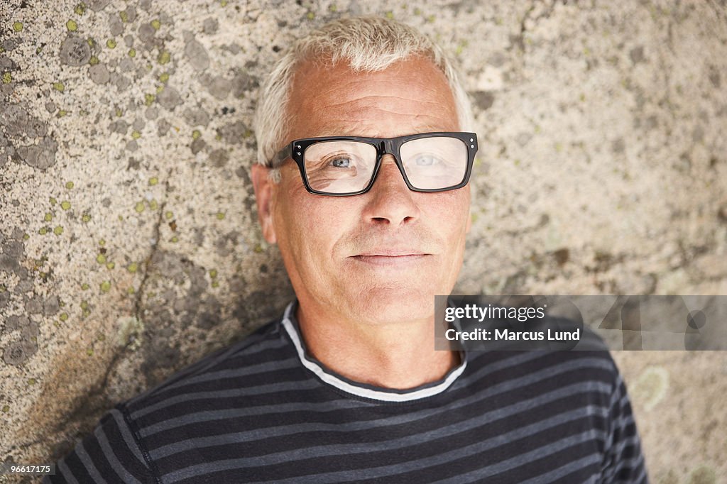 Middle aged man on rocks portrait