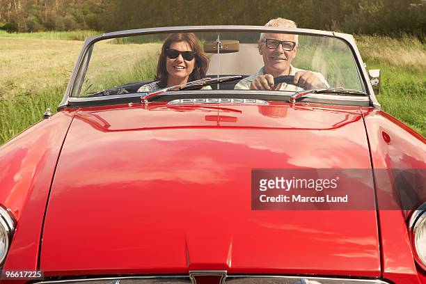 mid aged couple in sports car - lund sweden stock pictures, royalty-free photos & images