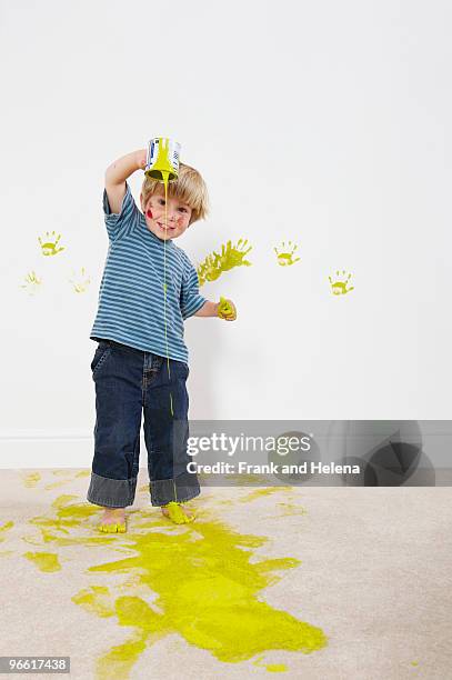toddler boy pouring paint onto carpet - damaged carpet stock pictures, royalty-free photos & images