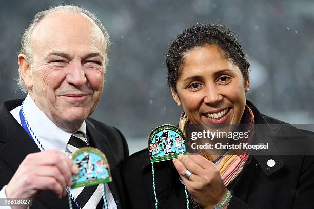 Steffi Jones, President of the Organising Committee Germany and president Rolf Koenigs of Gladbach pose with a carnival medal before the Bundesliga...