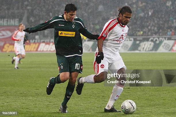 Raul Marcelo Bobadilla of Gladbach tackles Breno of Nuernberg during the Bundesliga match between Borussia Moenchengladbach and 1. FC Nuernberg at...