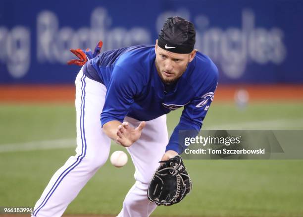 Josh Donaldson of the Toronto Blue Jays takes ground balls at third base during batting practice before the start of MLB game action against the...