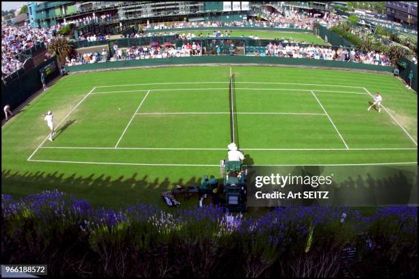 Wimbledon, uk june 26, 2001 spectator shadows start to edge their way across court #l8.German Nicolas Kiefer is on the right. He defeated Alex...