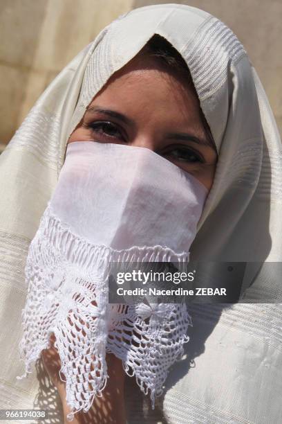 Femme algéroise portant une tenue traditionnelle le 'haik', étoffe symbole de pureté, dans une rue, le 21 mars 2013, à Alger, Algérie.