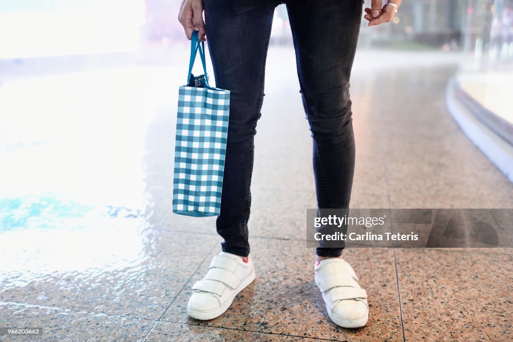 Fashionable man's legs with shopping bag