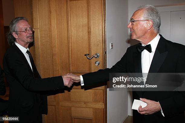 Austrian writer Peter Handke and German football legend Franz Beckenbauer shake hands during the Hubert Burda Birthday Reception at Munich royal...