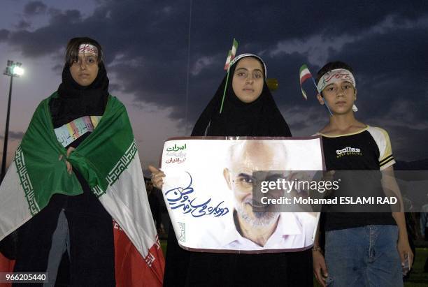 Supporters of outspoken reformist Mostafa Moin attend a pre-election gathering at a stadium in Tehran June 14, 2005. Moin , originally barred from...