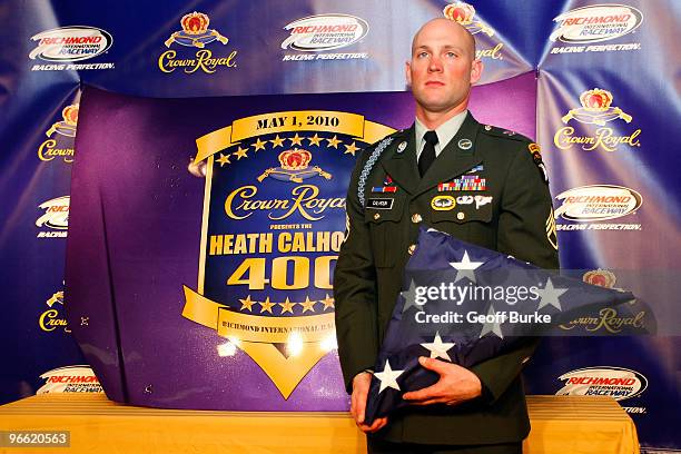 Retired Staff Sergeant Heath Calhoun poses on stage after a press conference at Daytona International Speedway on February 12, 2010 in Daytona Beach,...