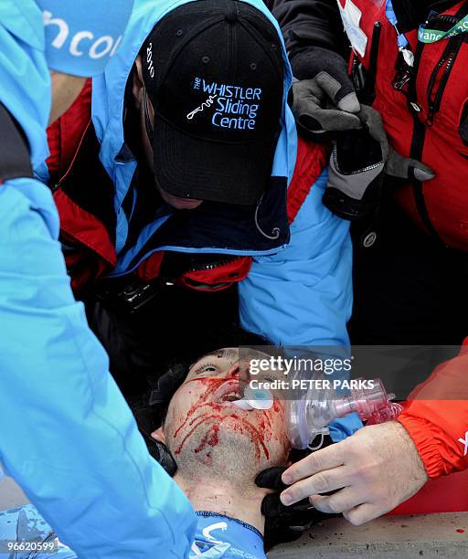 Georgian luge hopeful Nodar Kumaritashvili is assisted by medical personnel after crashing during the men's Luge practise at the Whistler Sliding...