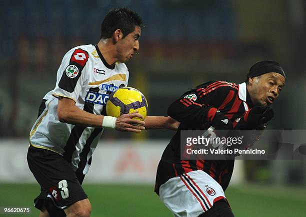 Ronaldo de Assis Moreira Gaucho Ronaldinho of AC Milan is challenged by Mauricio Isla of Udinese Calcio during the Serie A match between AC Milan and...