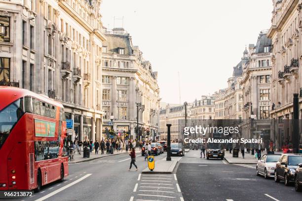 busy day on regent street with crowds of people and cars, london, england, uk - london england stock pictures, royalty-free photos & images