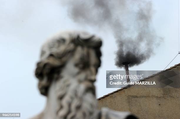 Black smoke rises fron the chimney of the Sistine Chapel on March 13, 2013 in the morning of the second day of the conclave.