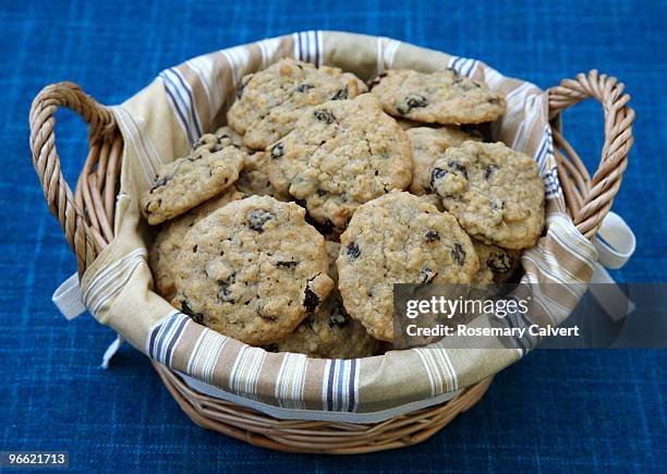 fresh homemade raisin & oatmeal cookies in basket. - oatmeal stock pictures, royalty-free photos & images