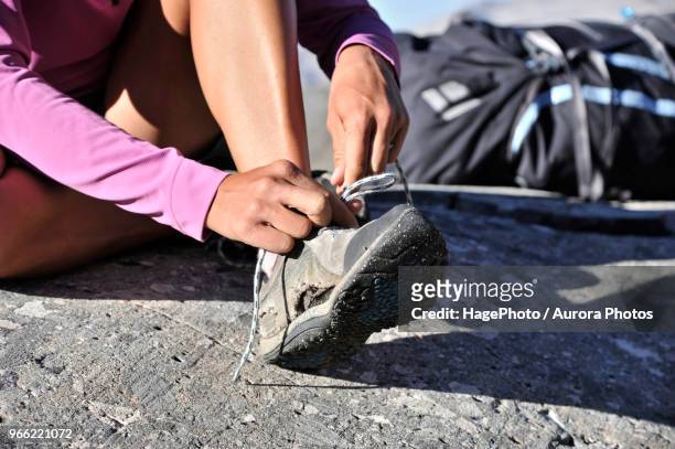 woman tying worn hiking boots, sierra high route, minarets wilderness, inyo national forest, california, usa - inyo national forest stock pictures, royalty-free photos & images