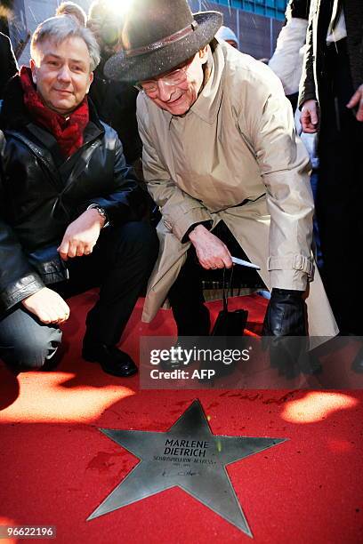 Berlin's Mayor Klaus Wowereit and Gero Gandert, director of the Deutsche Kinematek film museum pose for photographers during the unveiling of a star...