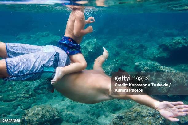 Father and son diving under water,Bali,Indonesia