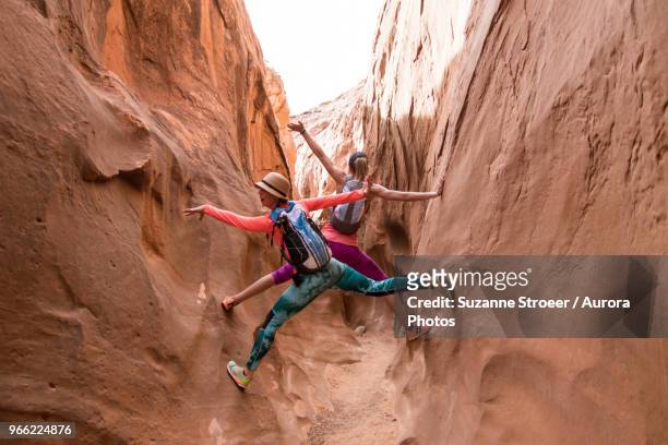 two women exploring slot canyon, grand staircase-escalante national monument, utah, usa - grand staircase escalante national monument stock-fotos und bilder