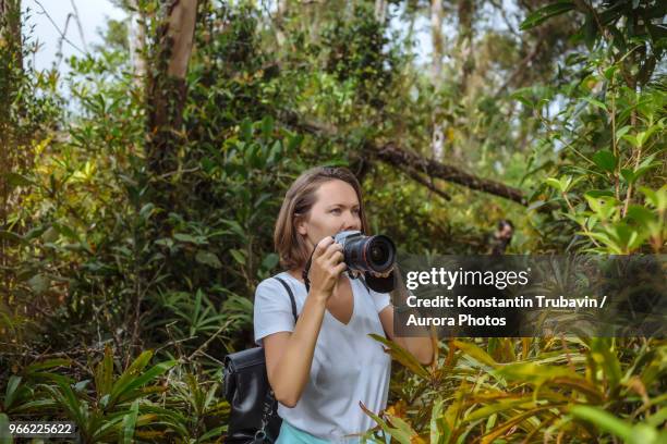 young woman with camera. - frauen mit fotoapparat stock-fotos und bilder