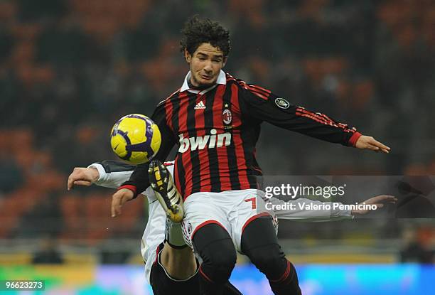 Alexandre Pato of AC Milan is challenged by Andrea Coda of Udinese Calcio during the Serie A match between AC Milan and Udinese Calcio at Stadio...