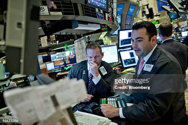 Andrew Heaney, center, works at a post on the floor of the New York Stock Exchange in New York, U.S., on Friday, Feb. 12, 2010. U.S. Stocks,...