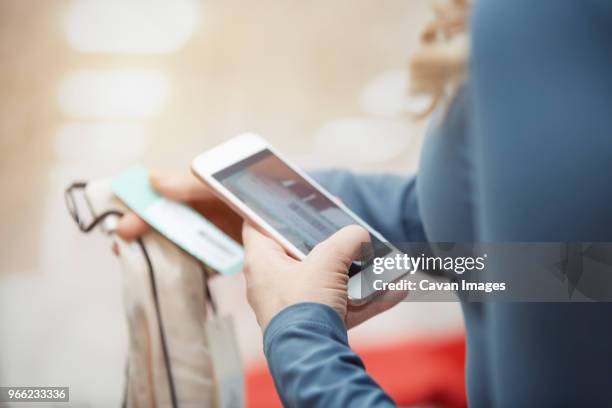 cropped image of customer photographing dress with smart phone in boutique - garment tag stock pictures, royalty-free photos & images