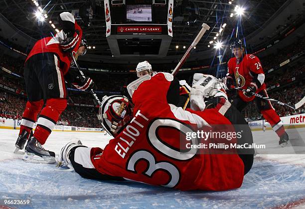 Goaltender Brian Elliott of the Ottawa Senators makes a save against the Calgary Flames during the game at Scotiabank Place on February 9, 2010 in...