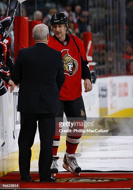 Alex Kovalev of the Ottawa Senators shakes hands with Bryan Murray during a presentation celebrating his 400 goals scored milestone before a game at...