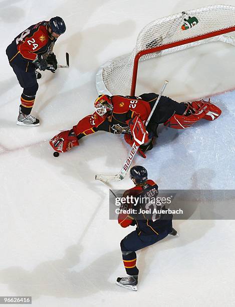 Bryan McCabe and Kamil Kreps watch as goaltender Tomas Vokoun of the Florida Panthers dives to make a save against the Vancouver Canucks on February...