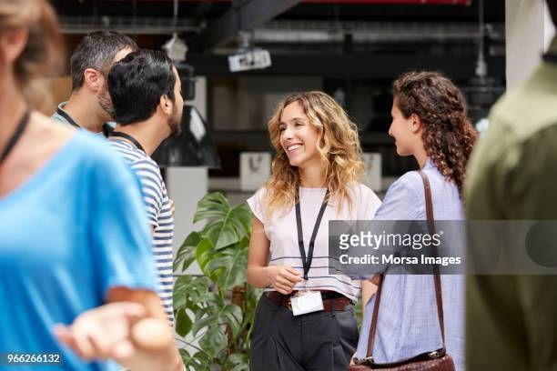 smiling business team standing during meeting - connection stock-fotos und bilder
